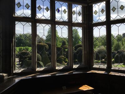 View of the world's oldest topiary garden from inside Levens Hall and Gardens, Cumbria, UK