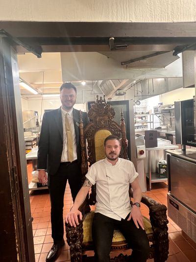 Langley Castle sous chef, Adam Phillips, in the Langley Castle kitchen (seated), with Food and Beverage Manager, Aiden McGuinness