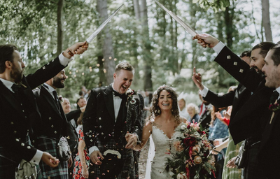 Couple Pippa-Rosy and Chris Parkes, marrying in the woodland wedding grove at Langley Castle, Northumberland, in July 2023.