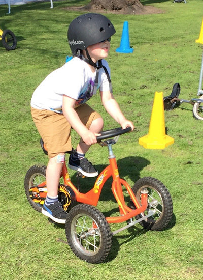 Youngster having a go on one of the bikes from Wonder Wheelers,