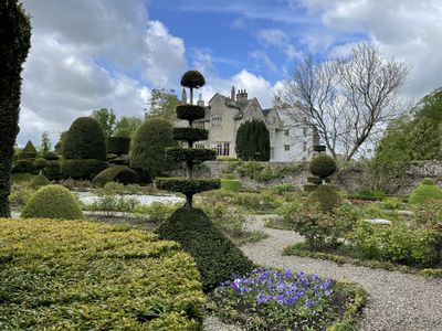 Part of the world's oldest topiary garden, with Levens Hall in the background