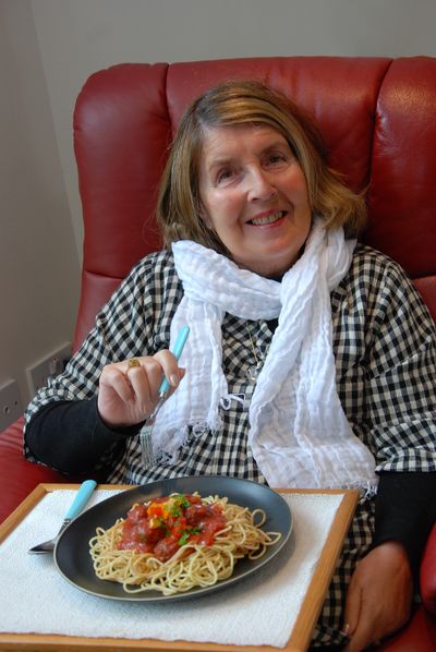 Lady getting ready to eat vegetarian spaghetti meal