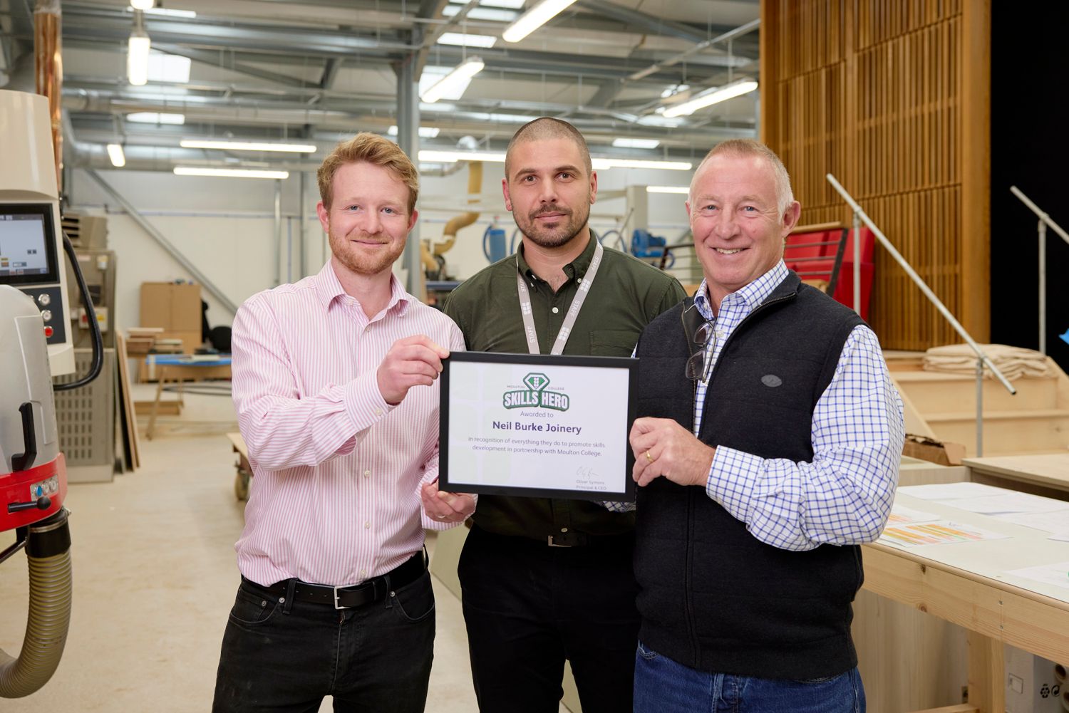 Moulton College's Adam Palmer presents NBJ with a Skills Heroes Award L-R Chris Burke Adam Palmer from Moulton College Neil Burke.jpg