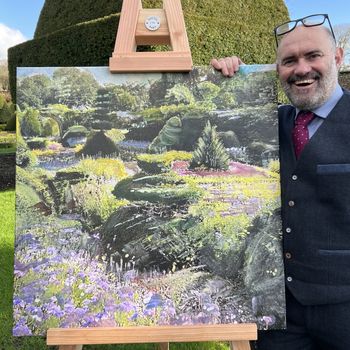 Artist Bob Sutcliffe with one of his paintings, at Levens Hall, Cumbria