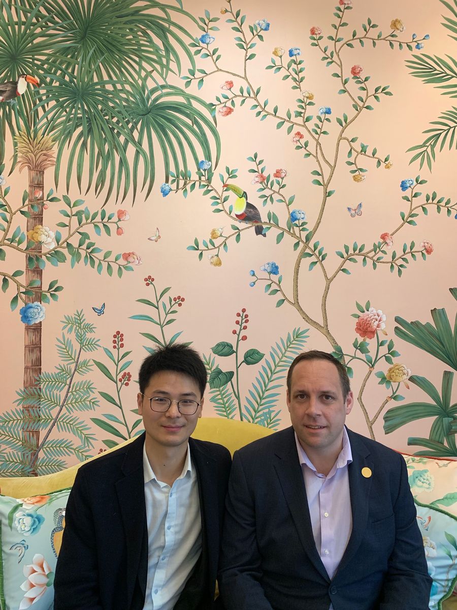 Richard Song de Gournay director China (left), Duncan Ray Focus SB head of strategic relationships (right) pictured with hand painted Amazonia Chinoiserie wallpaper on Florence Pink Dyed Silk.