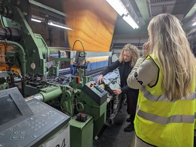 LCF Mill Visit - Andrea Noble showing students their designs being woven.jpg