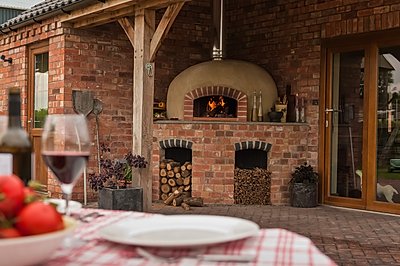 A Valoriani UK covered garden  installation of a wood fired pizza oven