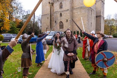 Benjamin and Annmarie Coomber, heading to  the tipi at medieval Langley Castle, Northumberland, on the day of their Viking wedding