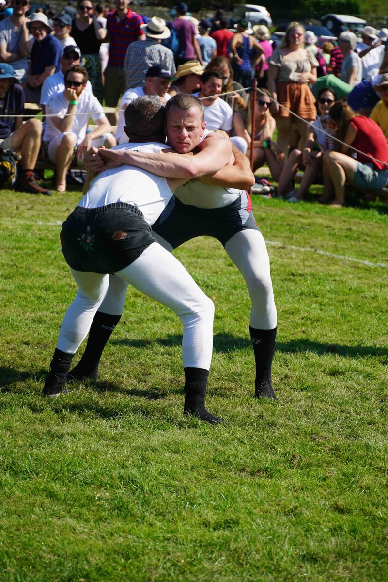 Male Cumberland and Westmorland wrestlers competing at Grasmere Lakeland Sports and Show.