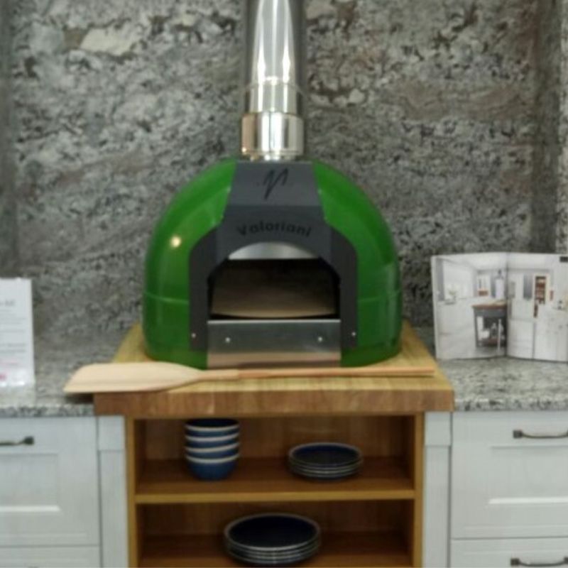 Cucina - the indoor version of the Fornino 60 oven - in an indoor kitchen setting and in a green colourway