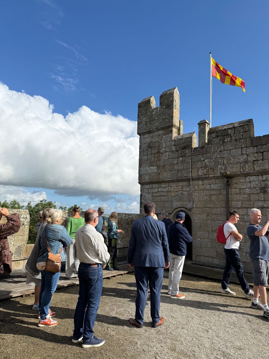 Langley Castle hotel guests on the Battlements, learning about the castle's history as part of the daily Battlements Tour.