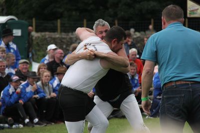 Jack Ewart and Stuart Fleming wrestling in a World Championship round at the Grasmere Lakeland Sports and Show 2023, in the Cumberland and Westmorland wrestling competition