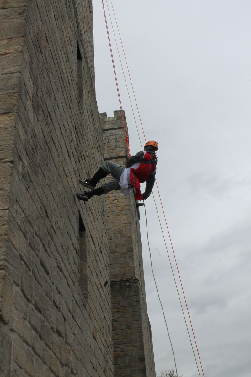 An intrepid knight clambers up  Langley Castle's walls 