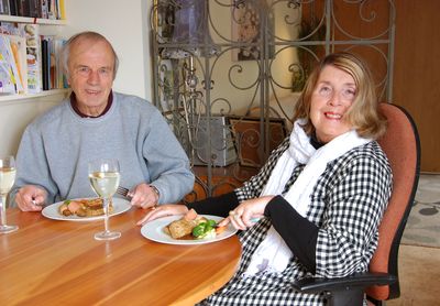 Couple seated at a dinner table eating vegetarian meal
