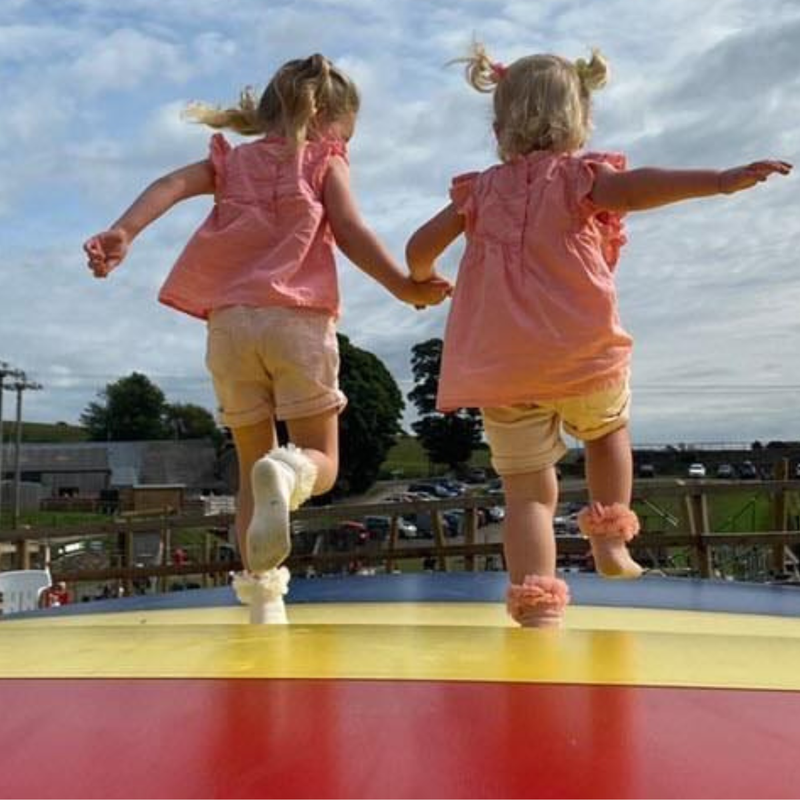 Children on giant air pillow bouncers at the Lakeland Maze Farm Park near Kendal, Cumbria