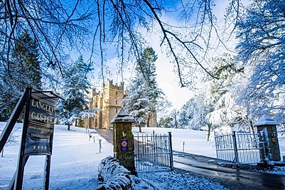 Langley Castle Hotel in the snow, as viewed from the front gate