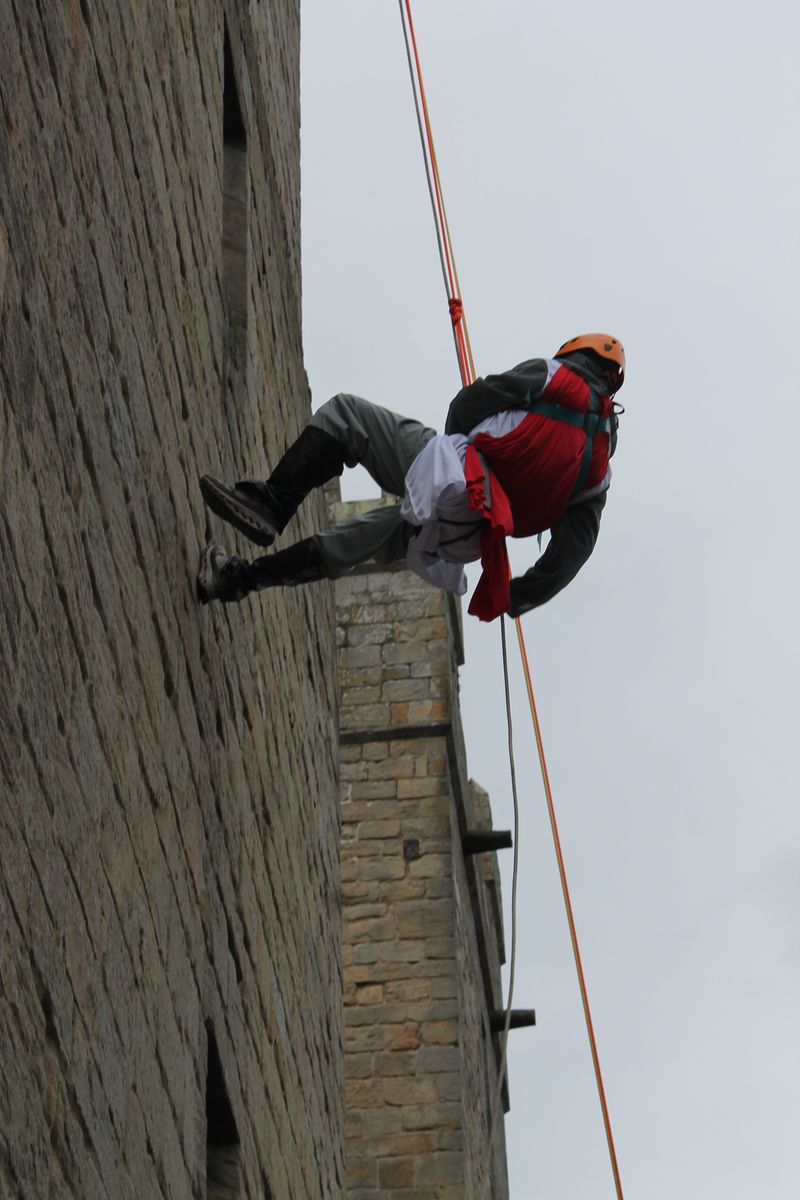An intrepid knight clambers up  Langley Castle's walls 