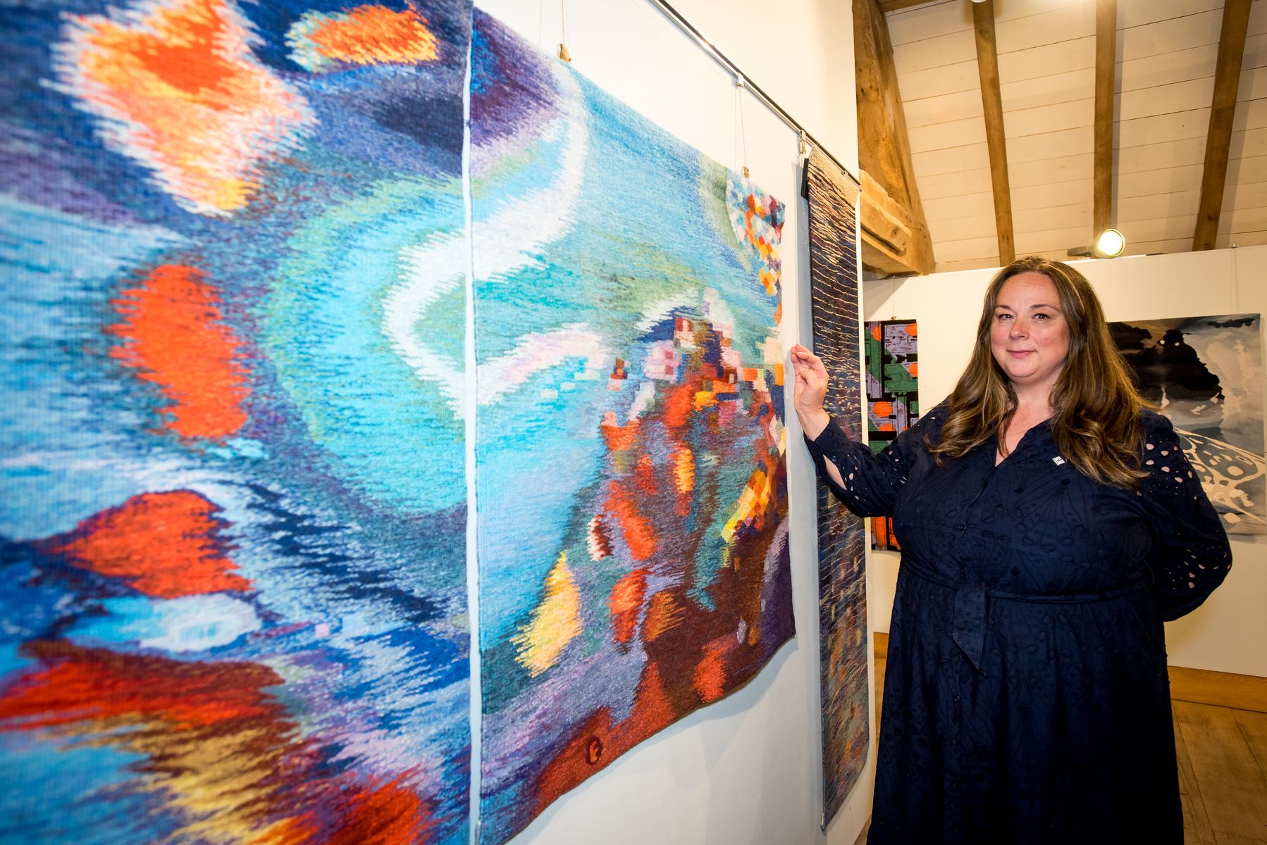 Weston Park’s Curatorial Development Co-ordinator Alison Poole admires one of the stunning works.jpg