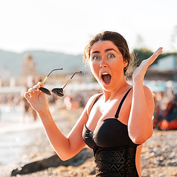 Woman suffering shock of discovering she's incurred serious sunburn whilst on the beach.