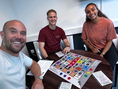 McCarron Coates director, Paul Coates, with members of the team, Tia Howard and Alex Fryer, and the Road Hierarchy game.