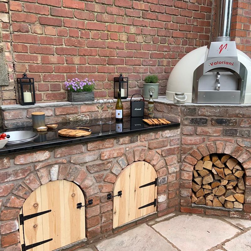 Cream-finish Fornino 75 oven incorporated into an outdoor kitchen design built in brick.