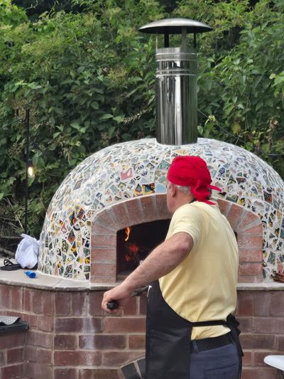 Andrew Manciocchi, owner of Orchard Ovens, cooking for guests at a customer's event, celebrating the 21st birthday of her son.