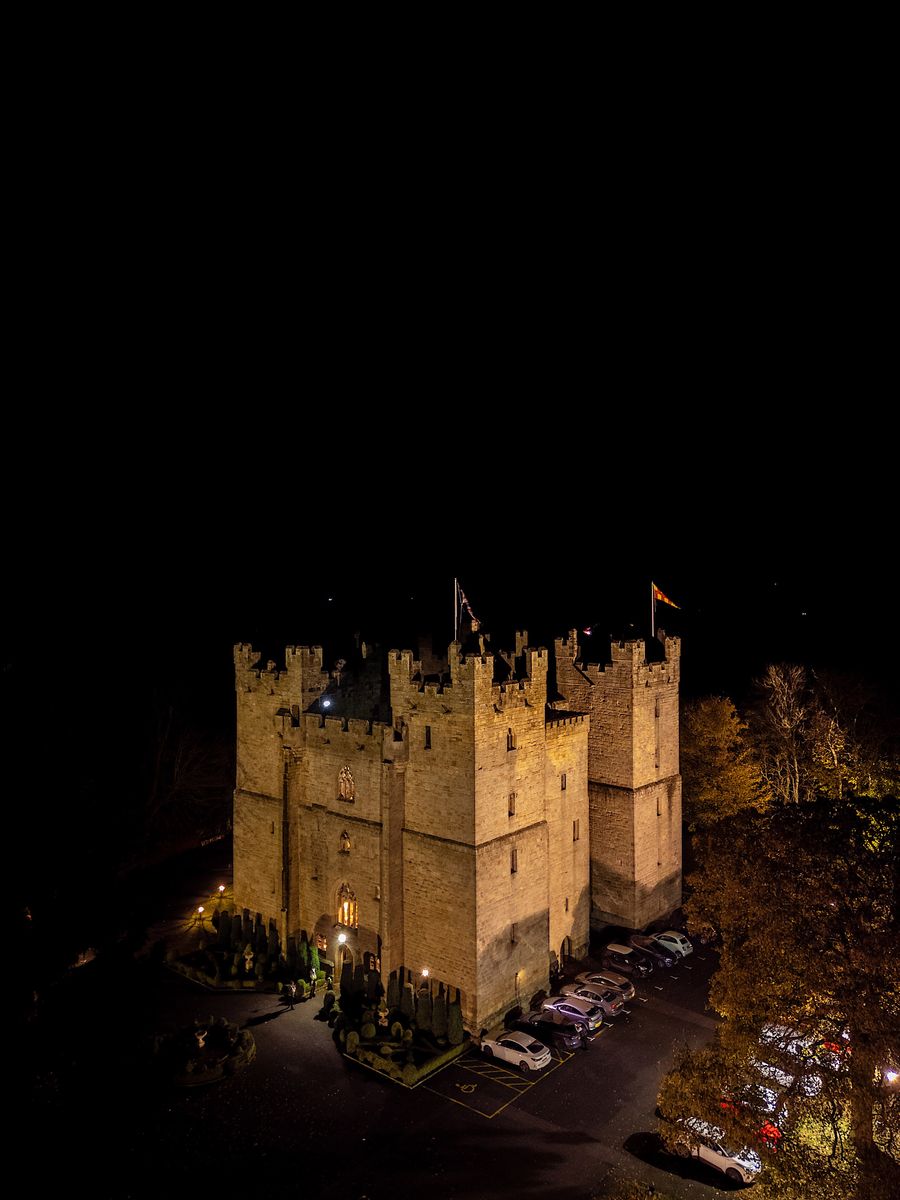 Langley Castle by night on the day of Viking wedding celebrations.
