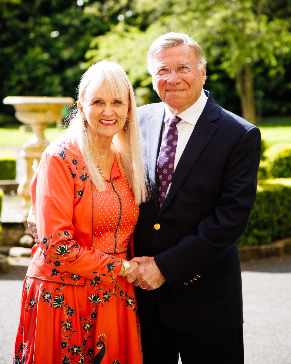 Baron and Baroness of Langley, Dr Stuart and Dr Mariann Madnick, by the fountain outside the medieval castle that Dr Stuart turned into a hotel and restaurant in 1986.