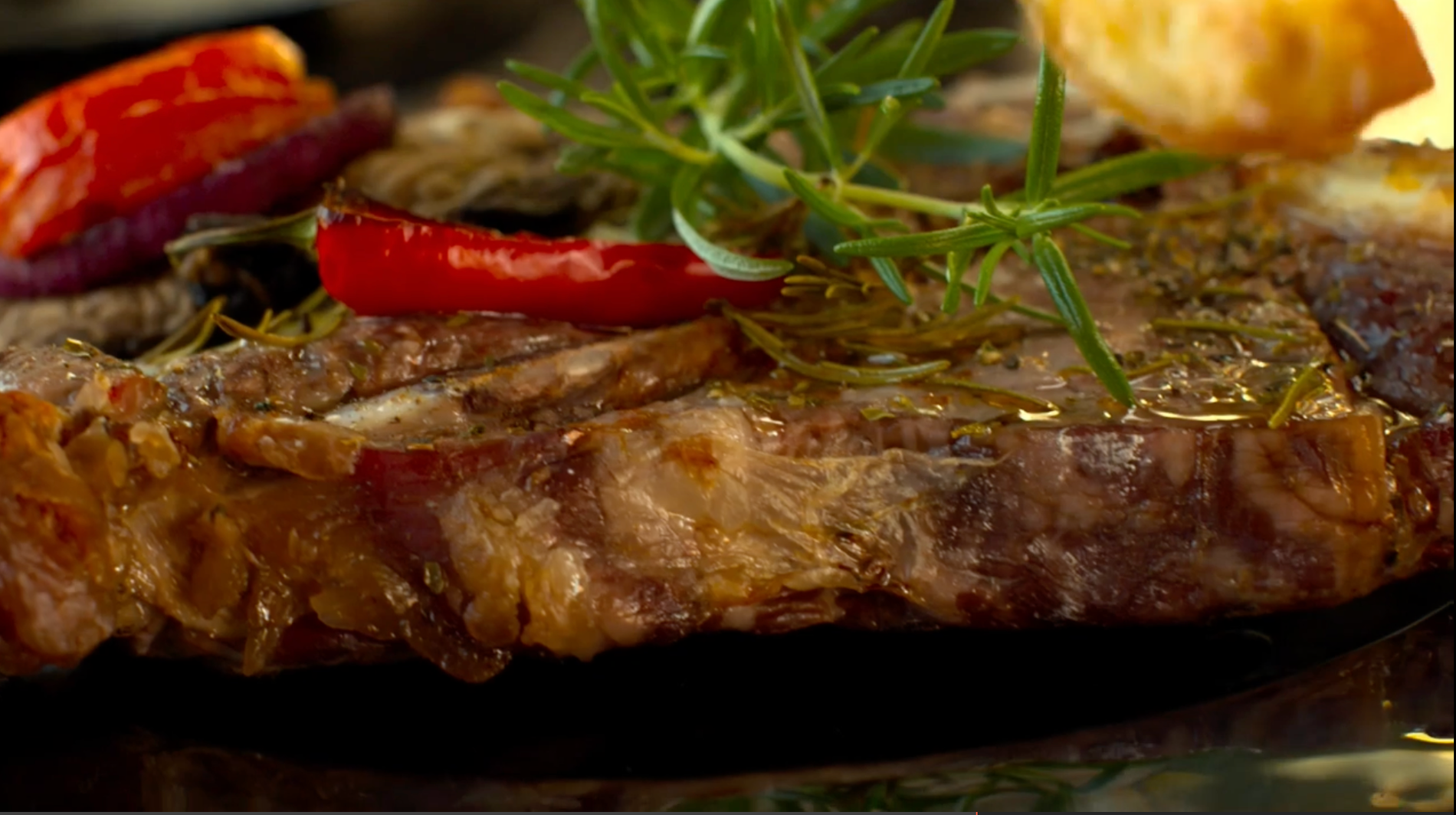 Steak, resting on a plate, having been cooked superbly in a Valoriani woodfired oven, supplied in the UK by Orchard Ovens.