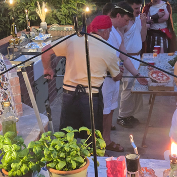 Andrew Manciocchi, owner of Orchard Ovens, cooking for guests at a customer's event, celebrating the 21st birthday of her son.