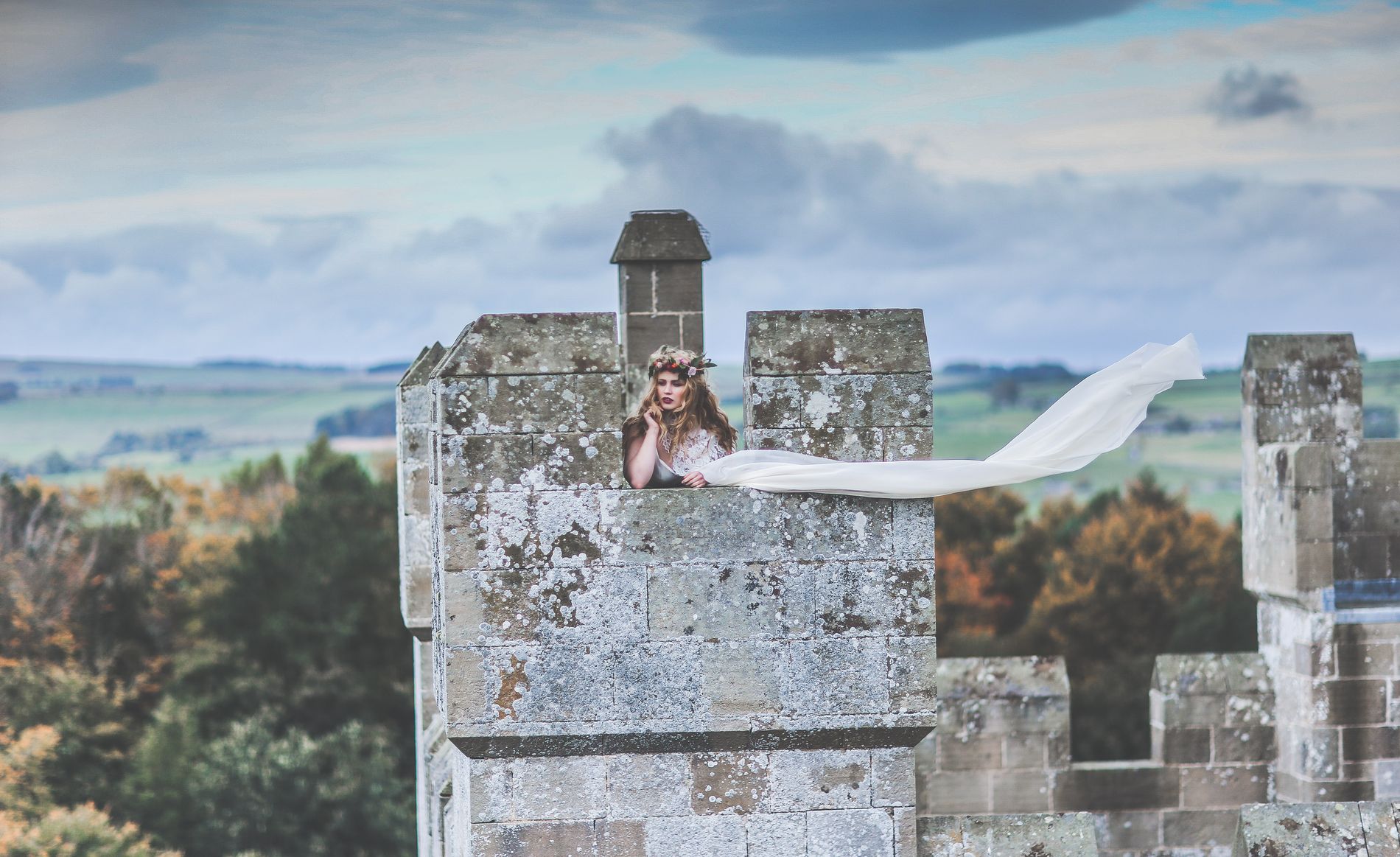 Woman on the battlements of Langley Castle Hotel, Northumberland, UK