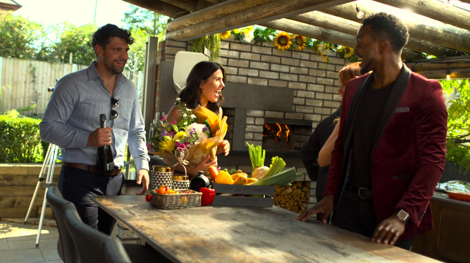 Guests arriving for some al fresco dining courtesy of a Valoriani wood-fired oven, as seen in the background.