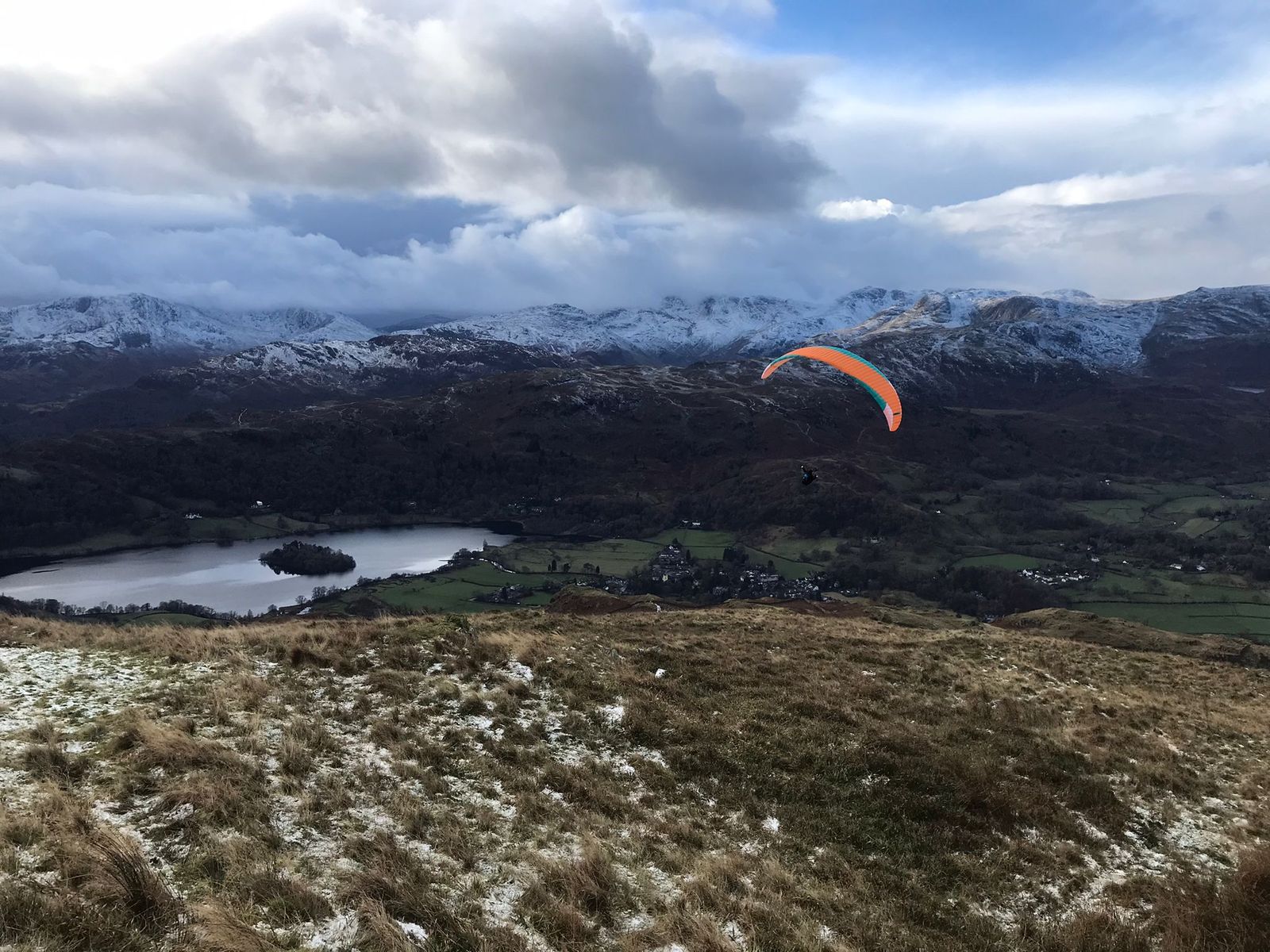 Paragliding in action over the glorious Lake District fells, providing a fabulous view of the landscape.