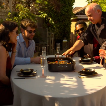 Serving guests dining al fresco around a Valoriani wood-fired oven.