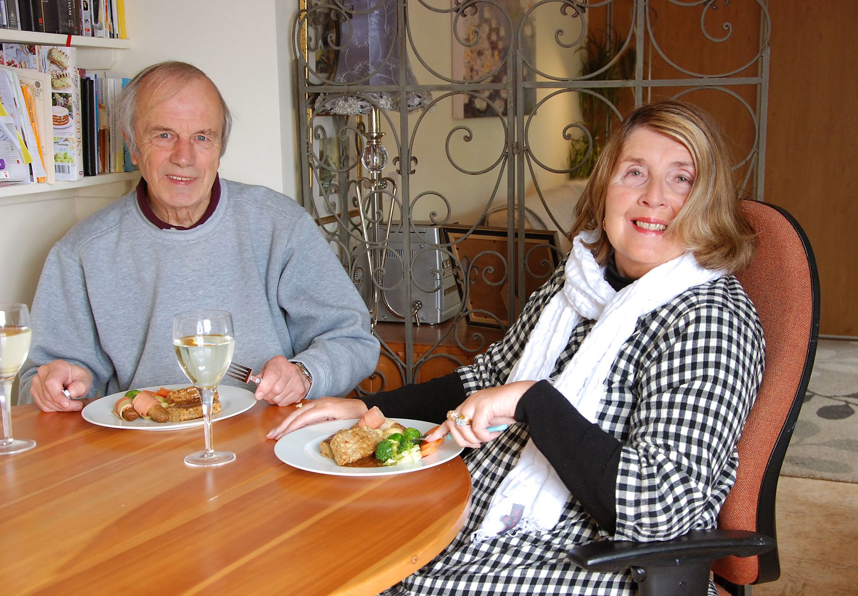 Couple seated at a dinner table eating vegetarian meal