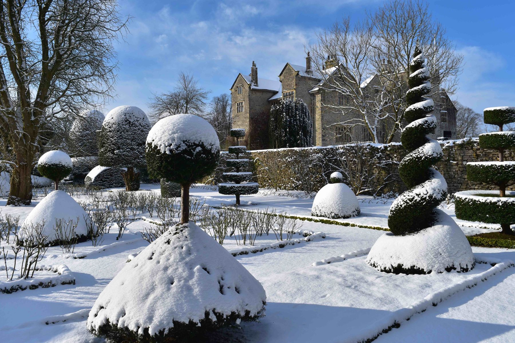 The world's oldest topiary garden at Levens Hall in snowy winter conditions