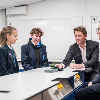 Duke of Westminster in school classroom with Dan Price and students