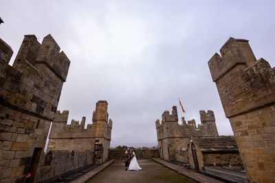 Benjamin and Annmarie Coomber, on the battlements of medieval Langley Castle, Northumberland, on the day of their Viking wedding