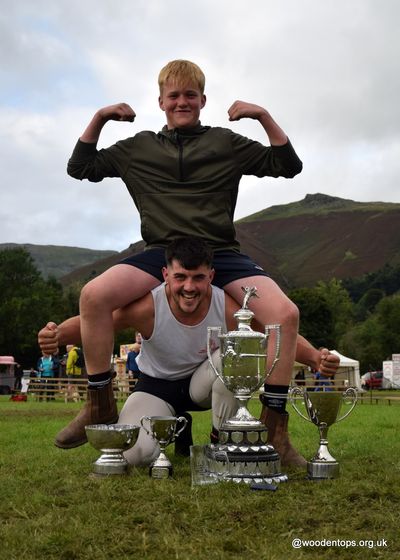 Thomas Gibson All Weights World Champion 2023 in Cumberland and Westmorland wrestling, in a contest won at Grasmere Lakeland Sports and Show, lifts one of the new 'names' in the sport, George Peacock.