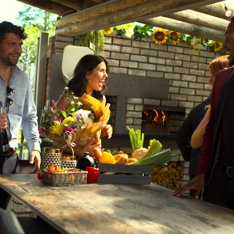 Guests arriving for some al fresco dining courtesy of a Valoriani wood-fired oven, as seen in the background.