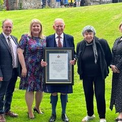 John Burns MBE receiving Honorary Fellowship for oustanding service to the community at the University of Wales Trinity St David.jpg