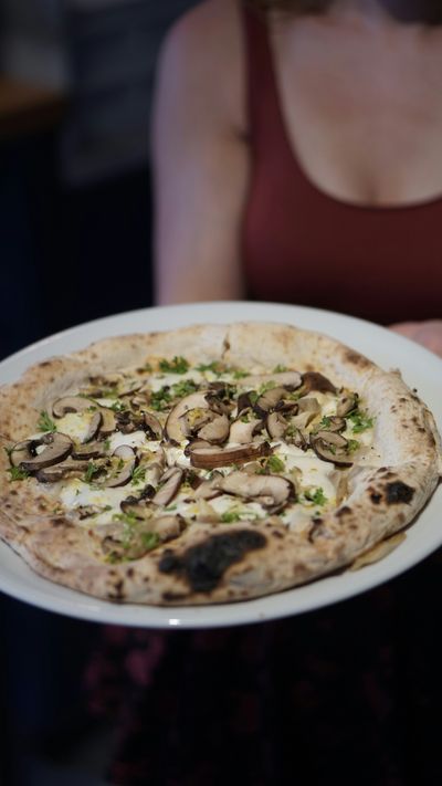 A burrata and mushroom woodfired pizza, using the creaminess of burrata cheese.