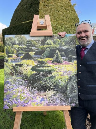 Artist Bob Sutcliffe with one of his paintings, at Levens Hall, Cumbria