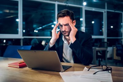 weary-businessman-finishing-up-work-night.jpg