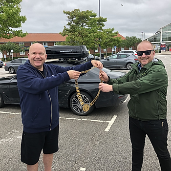 Richard Pyrah  outgoing GIMA President - passes on the GIMA chain of office to Simon McArdle in a socially distanced rendezvous.jpg