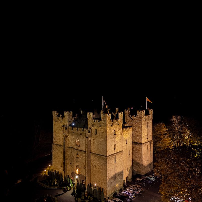Langley Castle by night on the day of Viking wedding celebrations.