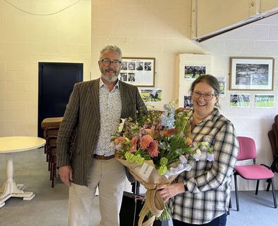 Chairman of Grasmere Lakeland Sports and Show, John Hibbert, presents Deborah Black with a bouquet of flowers.