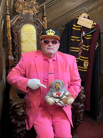 Mr Karoly Toth at Langley Castle, with mascot, Langley Bear.