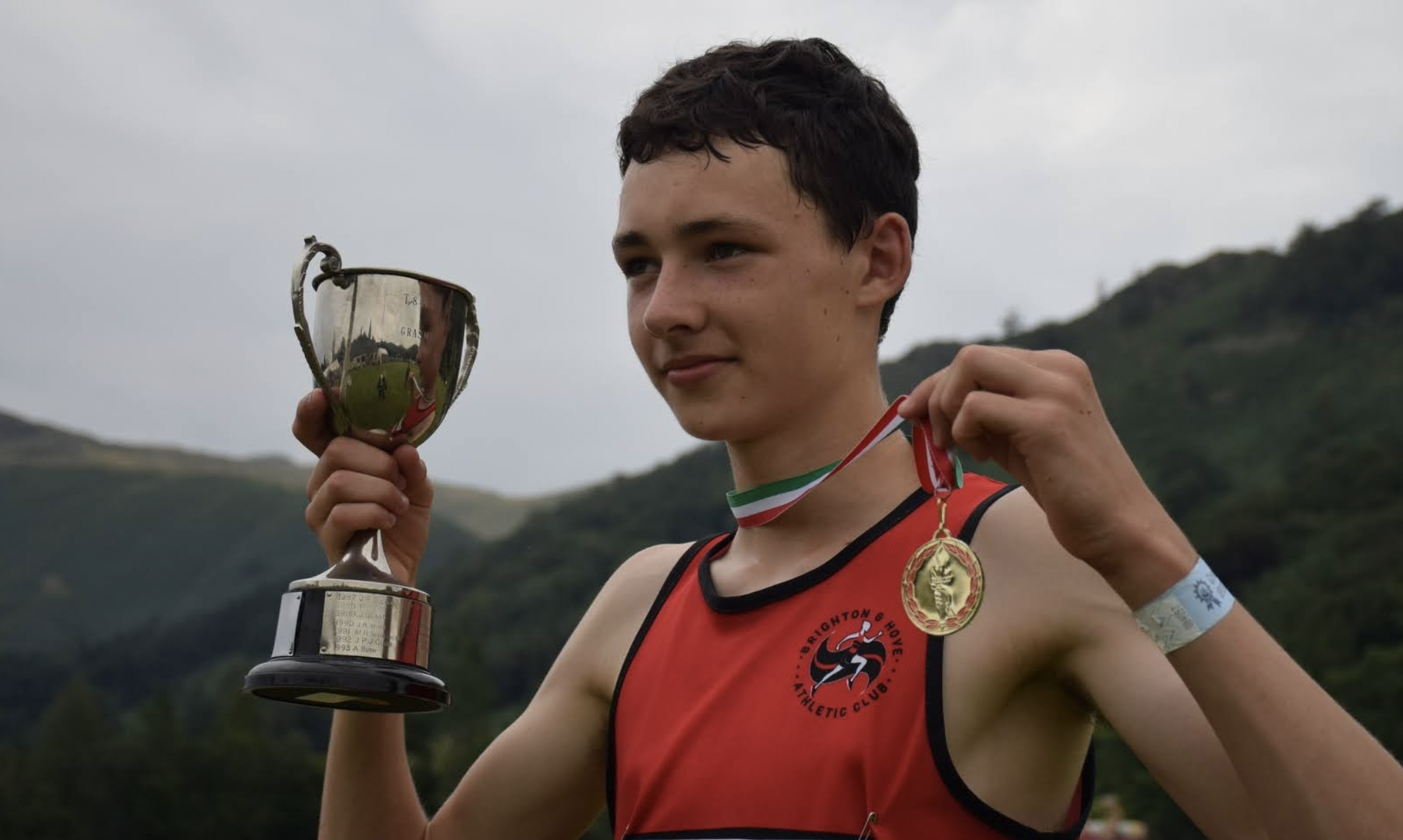 Finlay Goodman of Brighton & Hove, with cup and gold medal, pictured at Grasmere Sports 2022