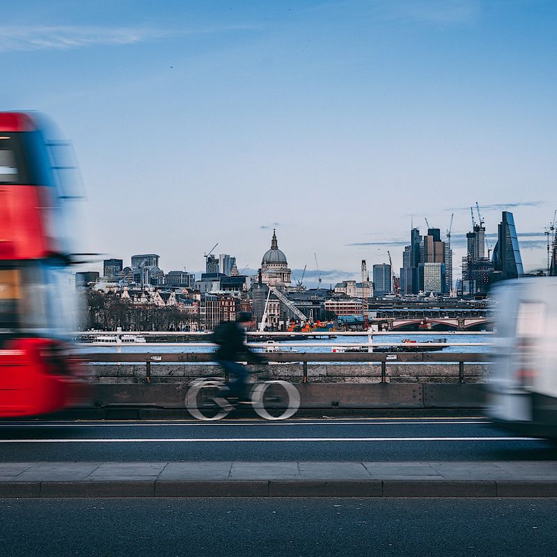 Bus and van sharing the road with a cyclist in London